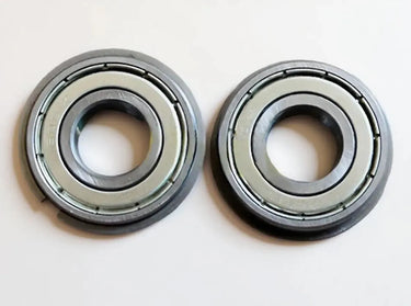 Two Canon IR5075 LOWER BERING metal ball bearings, each with a central hole, identical circular shapes, and a smooth metallic finish, are placed side by side on a white surface.